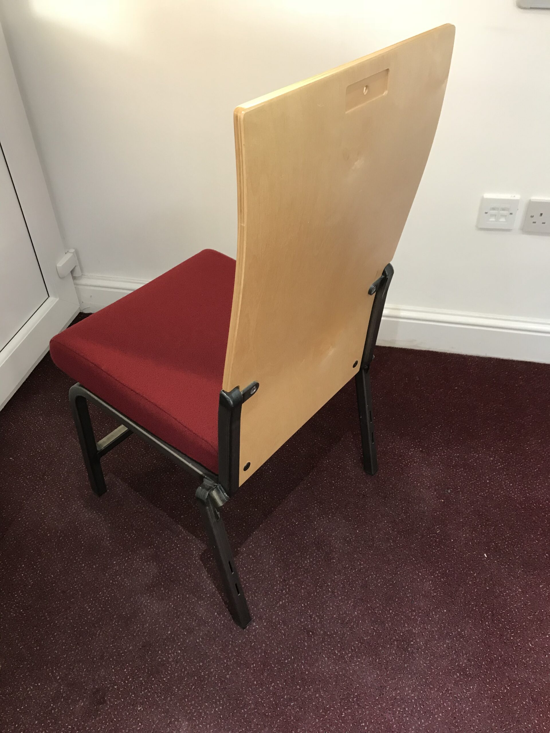 image of a sample auditorium stacking chair with custom wooden back